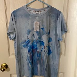 Soft blue flower Tee. Great with jeans size Large. Never worn brand new.